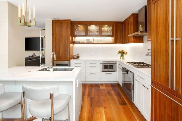 a kitchen with a sink stove and white cabinets