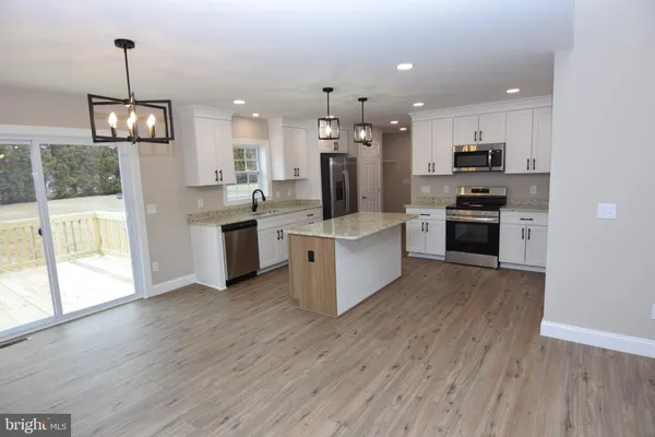 a large kitchen with stainless steel appliances kitchen island a large island in the center