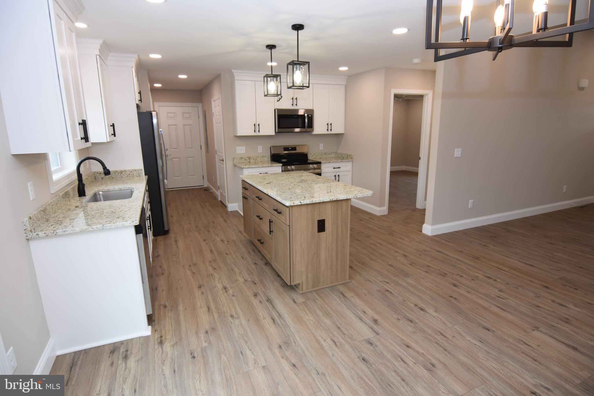 1 Briarhook Road Seaford, DE 19973 - Photo 3 of 15 a kitchen with kitchen island a stove a sink and a refrigerator