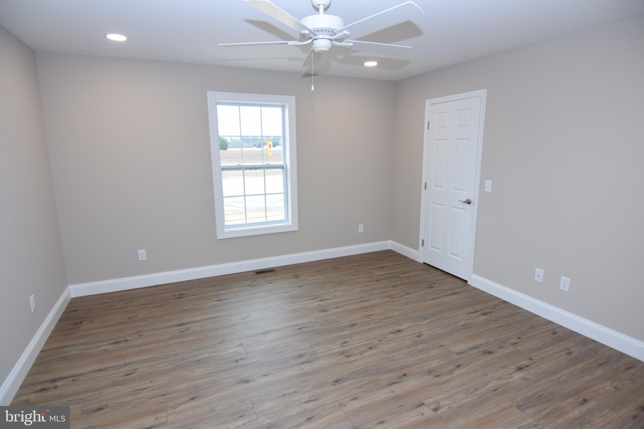 1 Briarhook Road Seaford, DE 19973 - Photo 6 of 15 an empty room with wooden floor window and ceiling fan