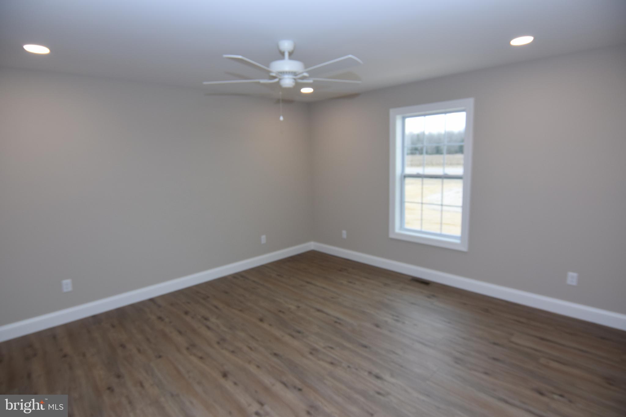 1 Briarhook Road Seaford, DE 19973 - Photo 7 of 15 a view of an empty room with wooden floor and a window