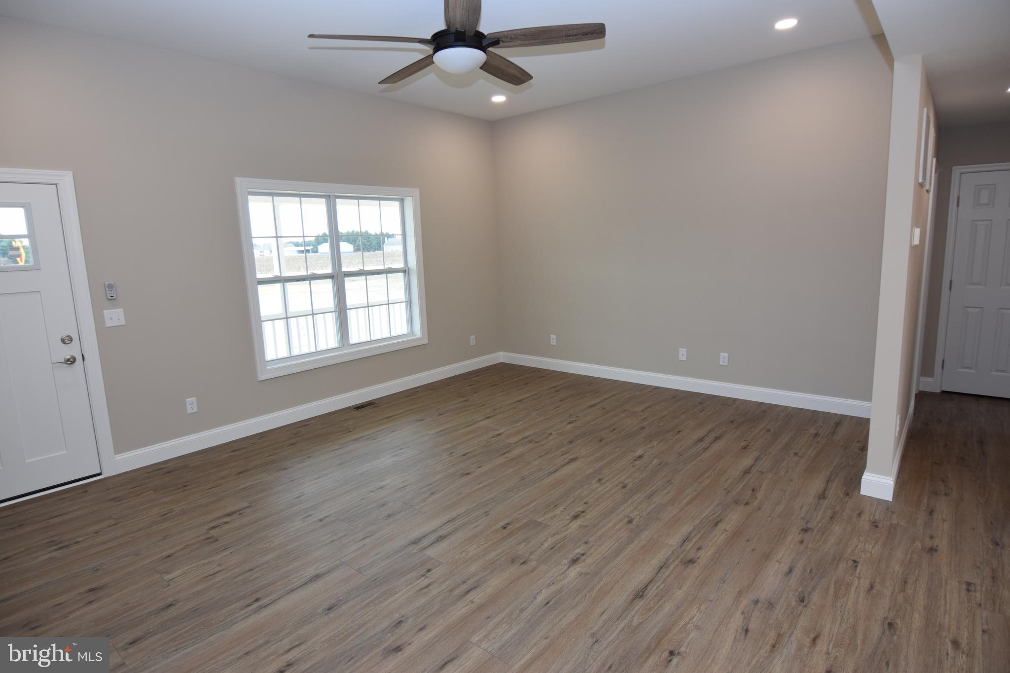 1 Briarhook Road Seaford, DE 19973 - Photo 8 of 15 an empty room with wooden floor fan and windows