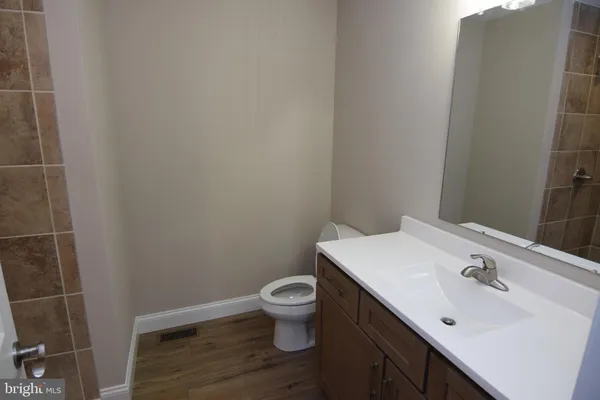 a bathroom with a sink toilet and vanity