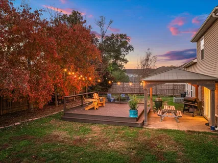 a view of a patio with table and chairs under an umbrella