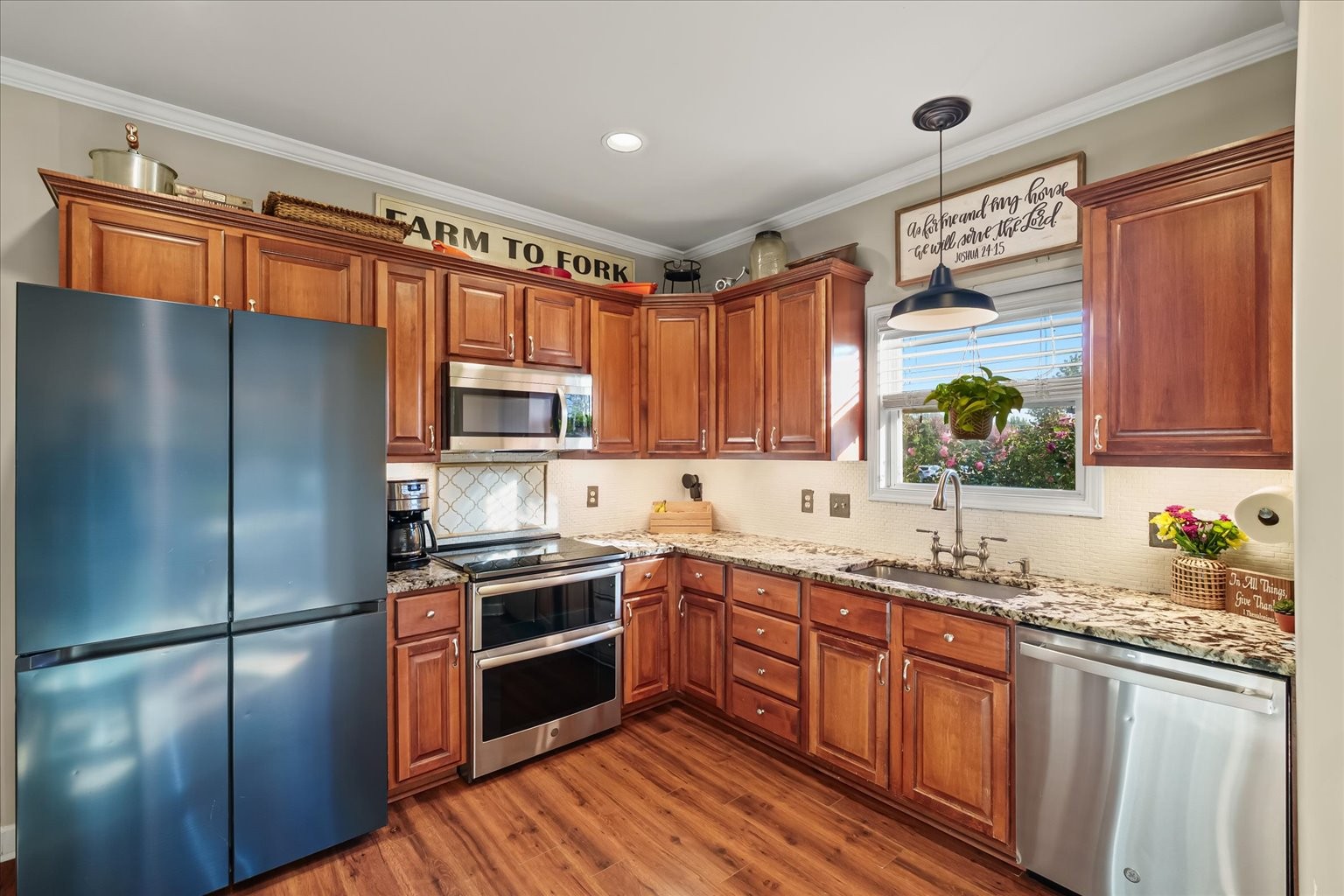 5001 Morning Dove Lane Spring Hill, TN 37174 - Photo 9 of 21 a kitchen with stainless steel appliances granite countertop a refrigerator a sink dishwasher a stove and white cabinets with wooden floor