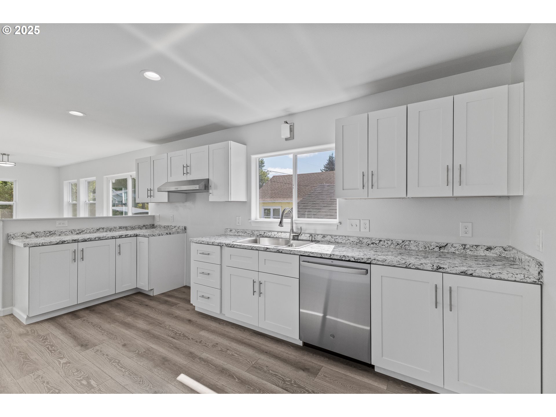 1175 North Dean Street Coquille, OR 97423 - Photo 13 of 34 a kitchen with a sink dishwasher white cabinets and refrigerator