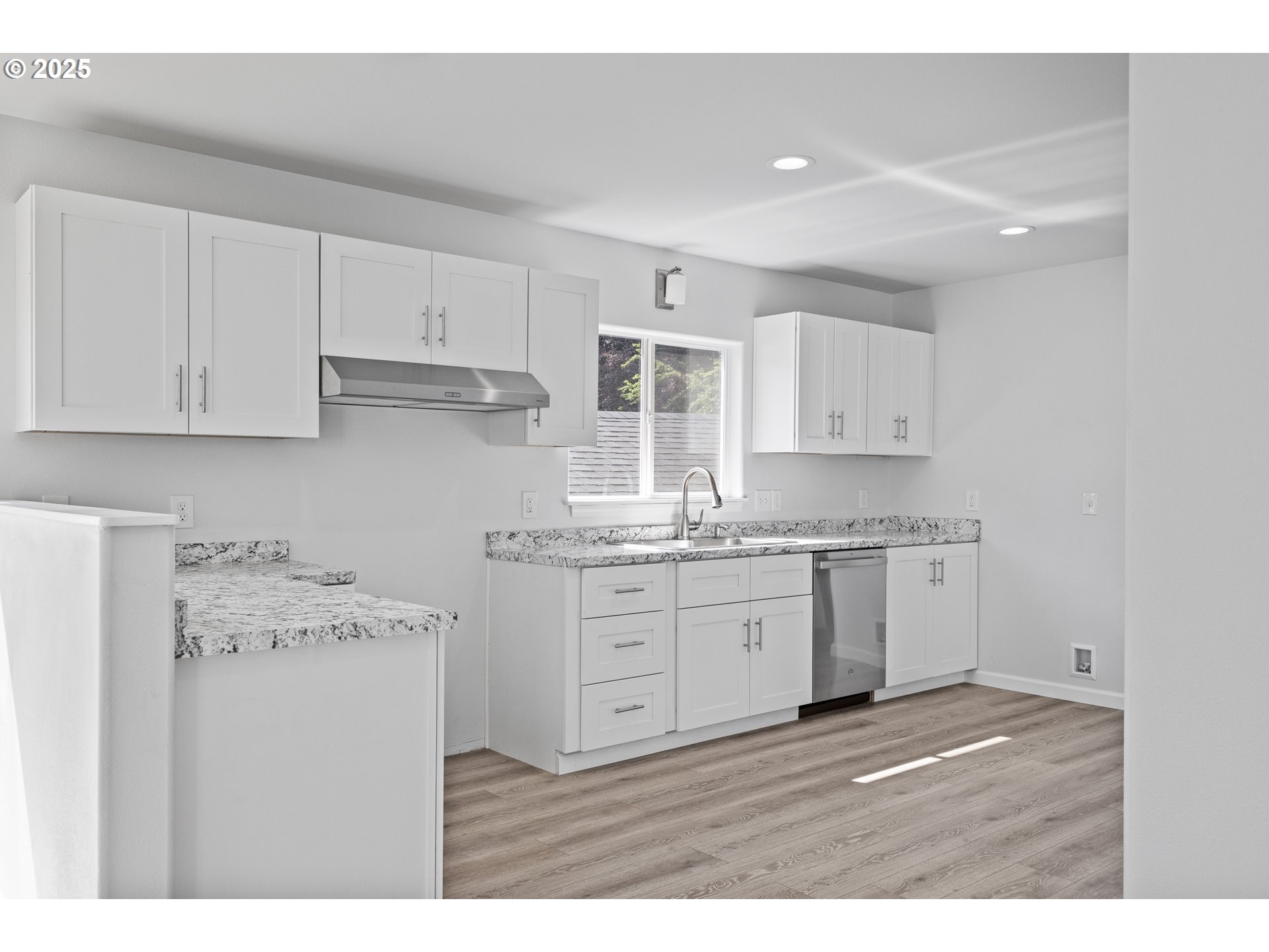 1175 North Dean Street Coquille, OR 97423 - Photo 14 of 34 a kitchen with granite countertop white cabinets and white appliances