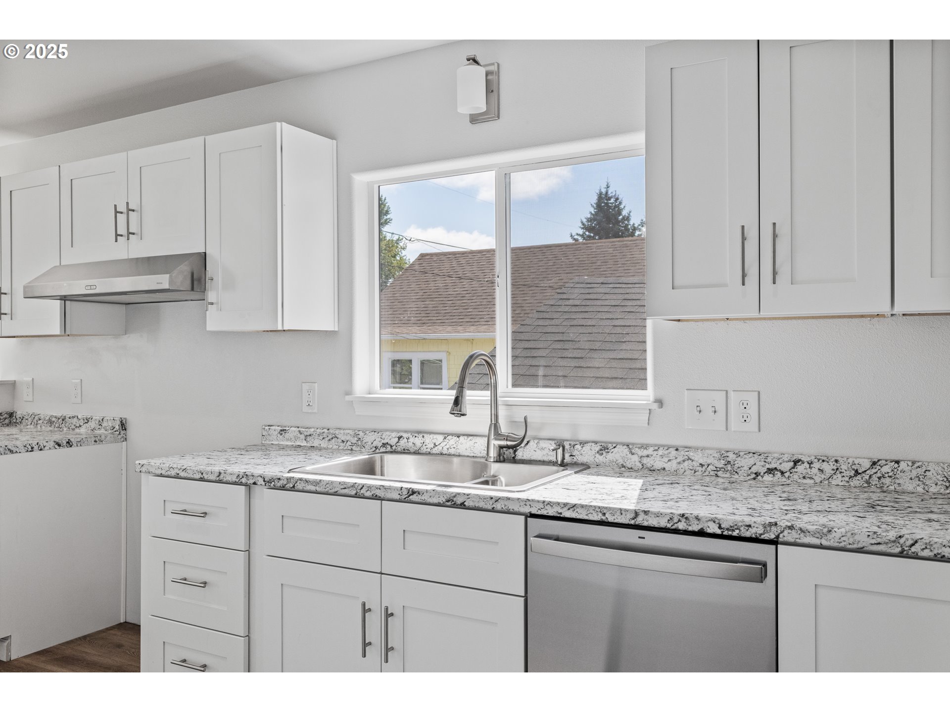 1175 North Dean Street Coquille, OR 97423 - Photo 18 of 34 a kitchen with granite countertop white cabinets and a sink