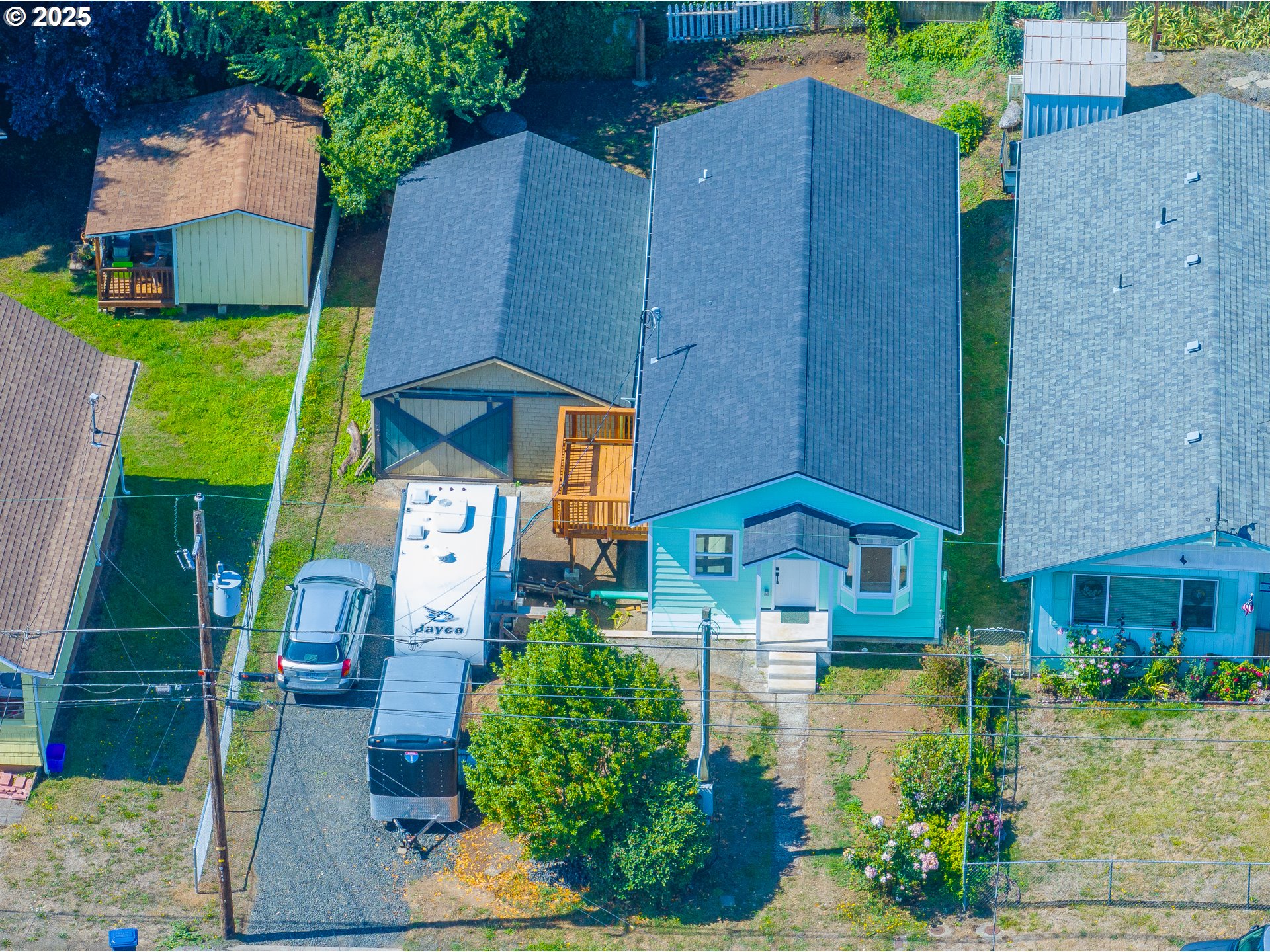 1175 North Dean Street Coquille, OR 97423 - Photo 2 of 34 an aerial view of a house with garden space and a car park in front of it