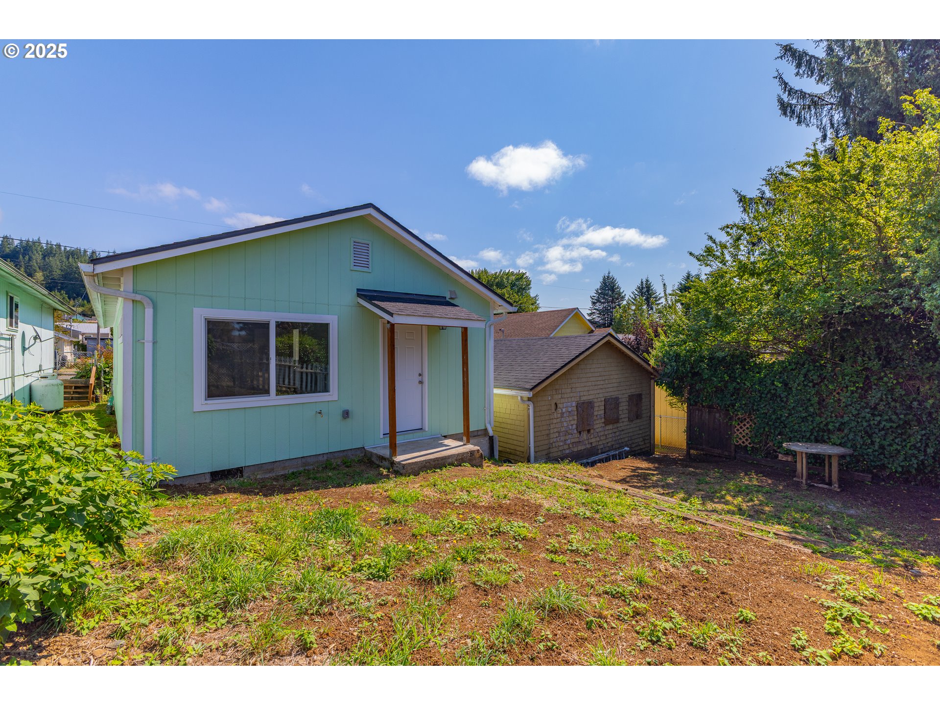 1175 North Dean Street Coquille, OR 97423 - Photo 8 of 34 a house with trees in the background