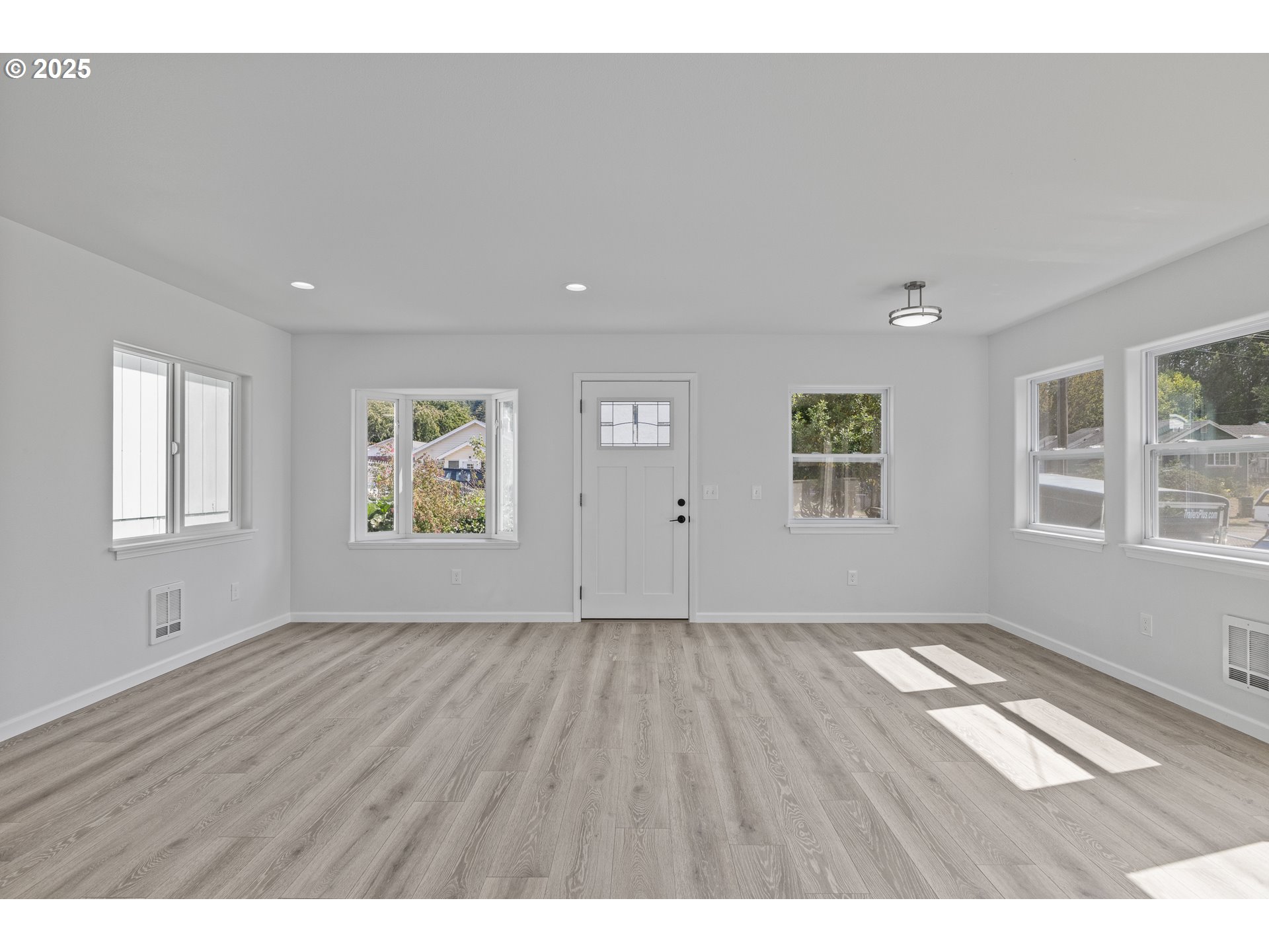 1175 North Dean Street Coquille, OR 97423 - Photo 9 of 34 wooden floor in an empty room with a window