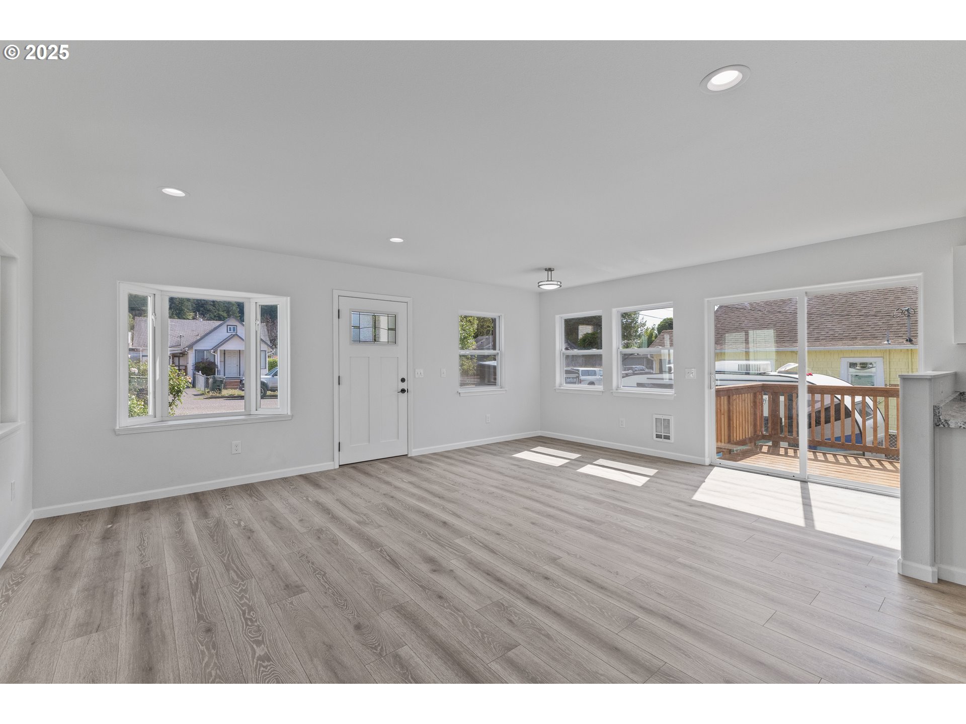 1175 North Dean Street Coquille, OR 97423 - Photo 10 of 34 a view of an empty room with wooden floor and a window