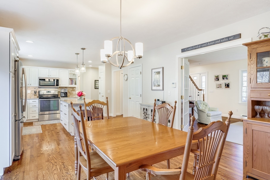 2 Briar Patch Circle Sandwich, MA 02537 - Photo 11 of 42 a view of a dining room and livingroom with furniture wooden floor a chandelier