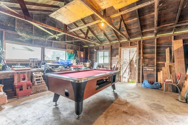 a outdoor sitting area with a table and chairs