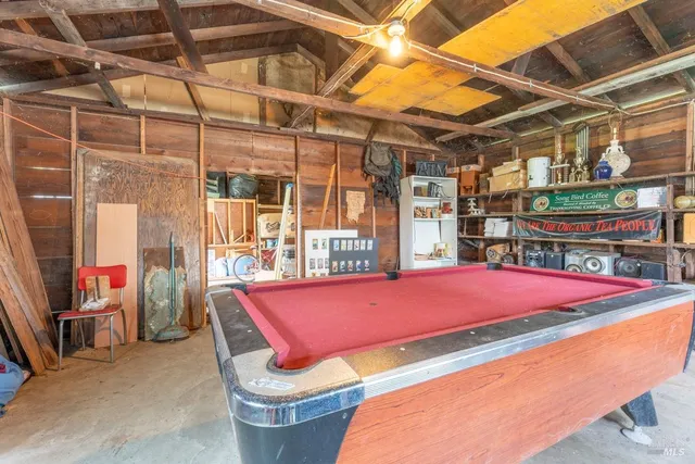 a patio with a table and chairs and barbeque