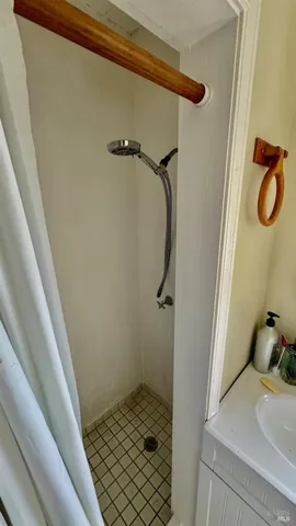 a bathroom with a granite countertop shower and a sink