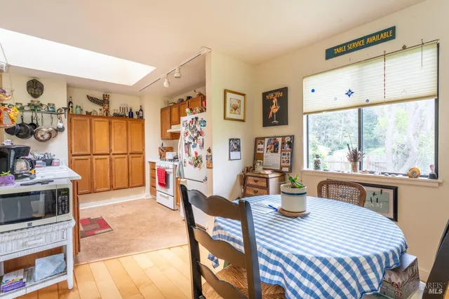 a kitchen with stainless steel appliances granite countertop a stove a sink dishwasher and a refrigerator with wooden floor