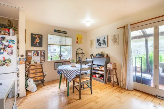 a dining room with furniture and wooden floor