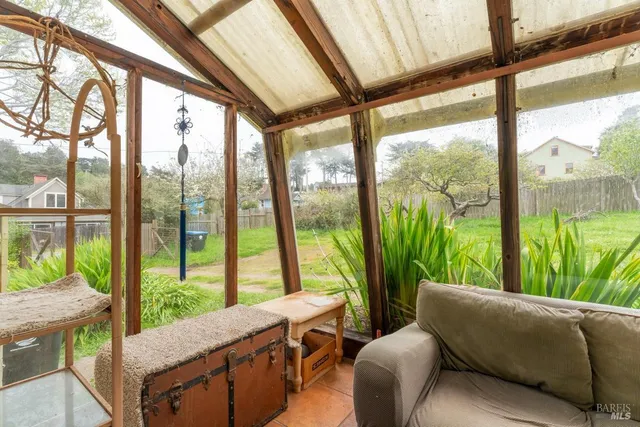 a living room with a large bed and a large window