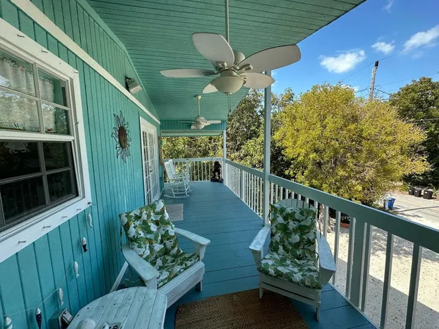 a view of a balcony with wooden floor