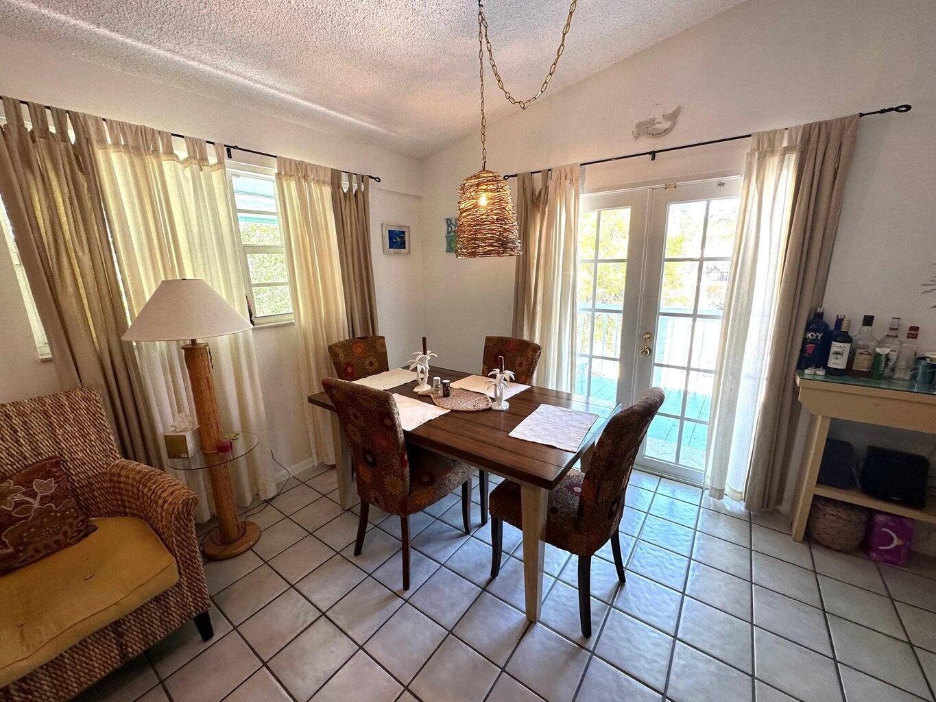 410 Mahogany Avenue Key Largo, FL 33037 - Photo 10 of 18 a view of a dining room with furniture window and outside view
