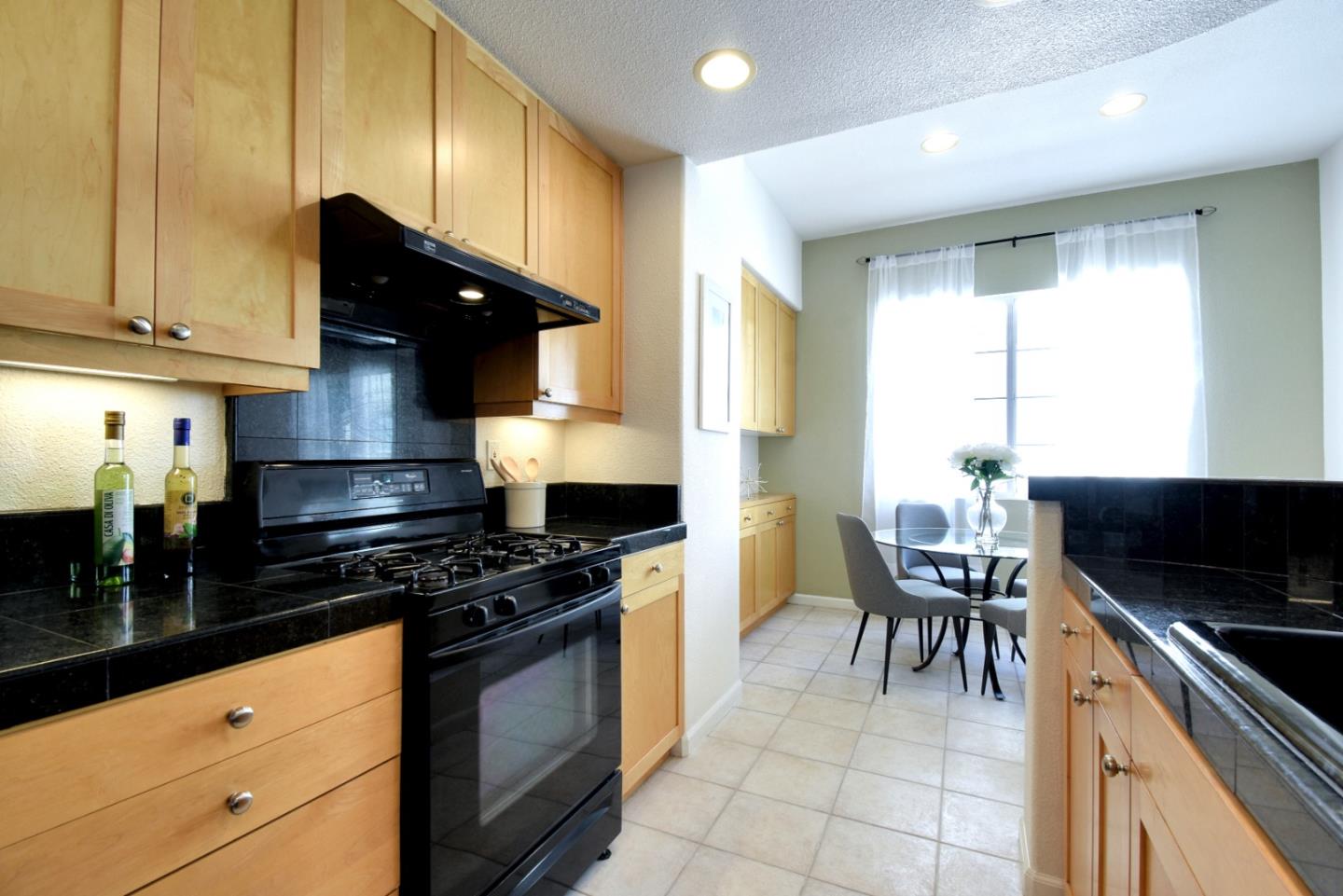 842 Wind Walk Milpitas, CA 95035 - Photo 12 of 45 a kitchen with granite countertop a stove a sink and a microwave