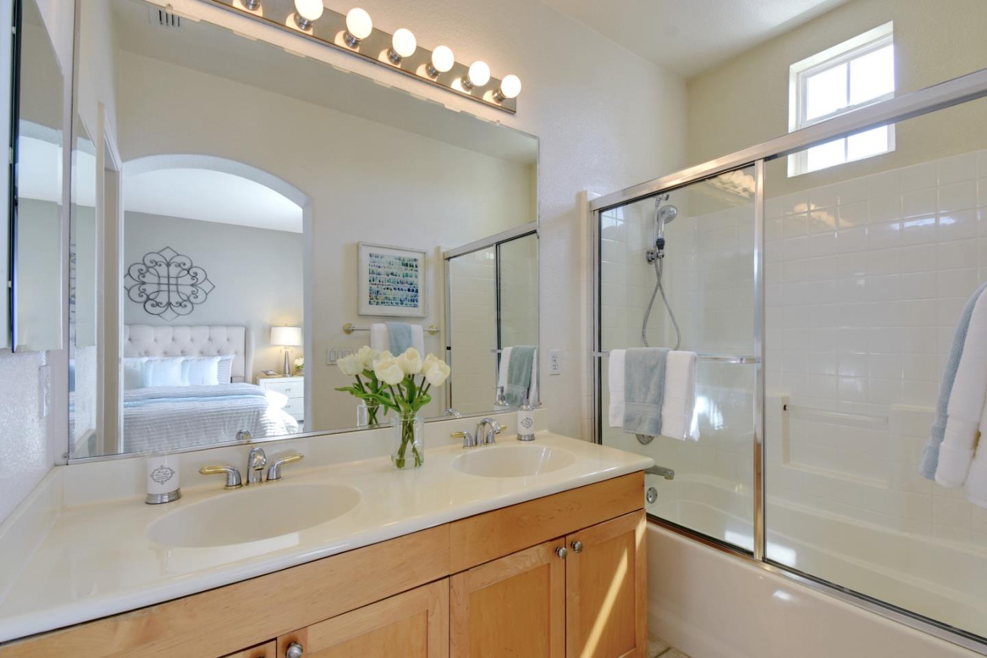 842 Wind Walk Milpitas, CA 95035 - Photo 22 of 45 a bathroom with a granite countertop sink a shower and a mirror