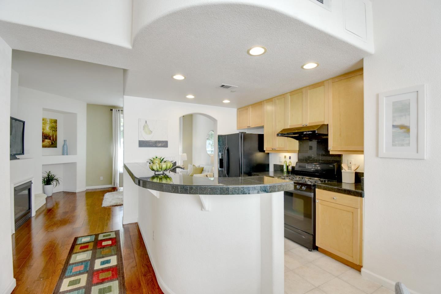 842 Wind Walk Milpitas, CA 95035 - Photo 7 of 45 a kitchen with stainless steel appliances kitchen island granite countertop a stove and a sink