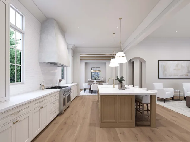 a large kitchen with a large island in white cabinets a sink dishwasher a dining table and chairs with wooden floor