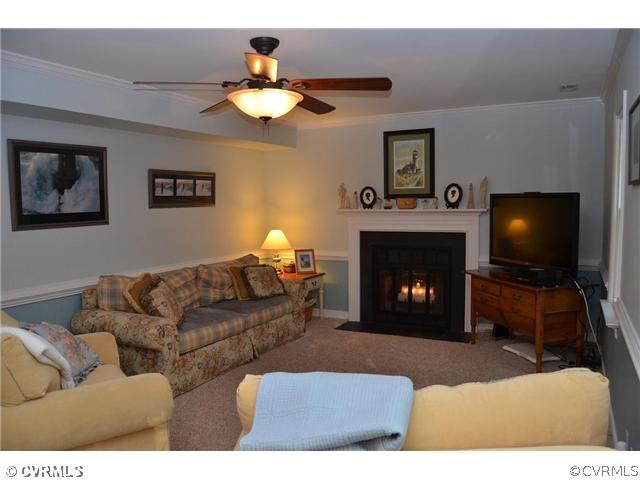 13802 Turtle Hill Road Midlothian, VA 23112 - Photo 5 of 12 a living room with furniture a fireplace and a flat screen tv