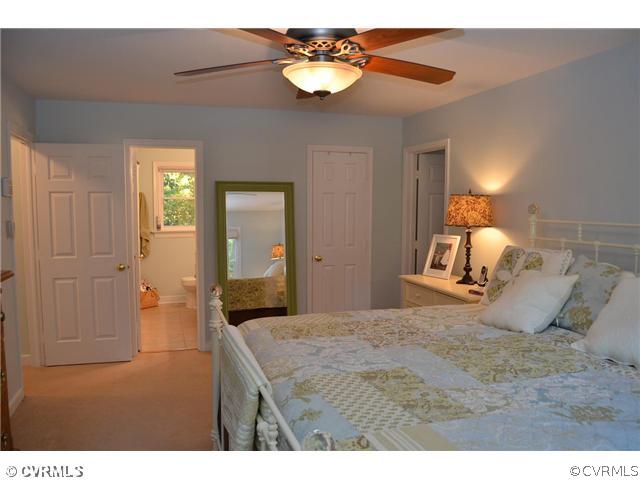 13802 Turtle Hill Road Midlothian, VA 23112 - Photo 9 of 12 a bedroom with a bed and a chandelier