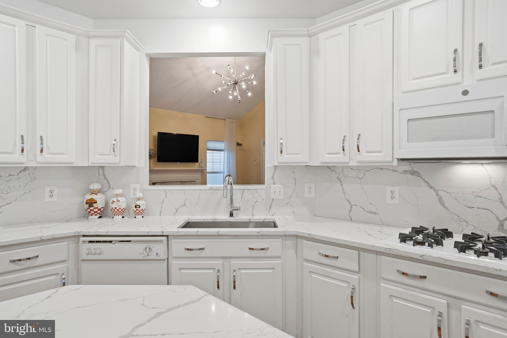 8941 Griffin Way, Unit 8941 Baltimore, MD 21208 - Photo 11 of 49 a kitchen with white cabinets and sink