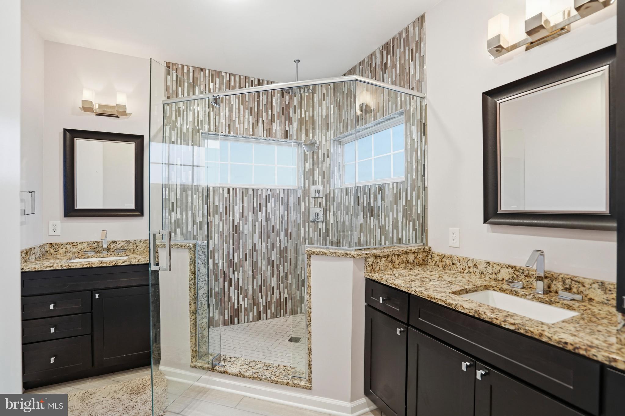 8941 Griffin Way, Unit 8941 Baltimore, MD 21208 - Photo 21 of 49 a bathroom with a granite countertop sink and a mirror