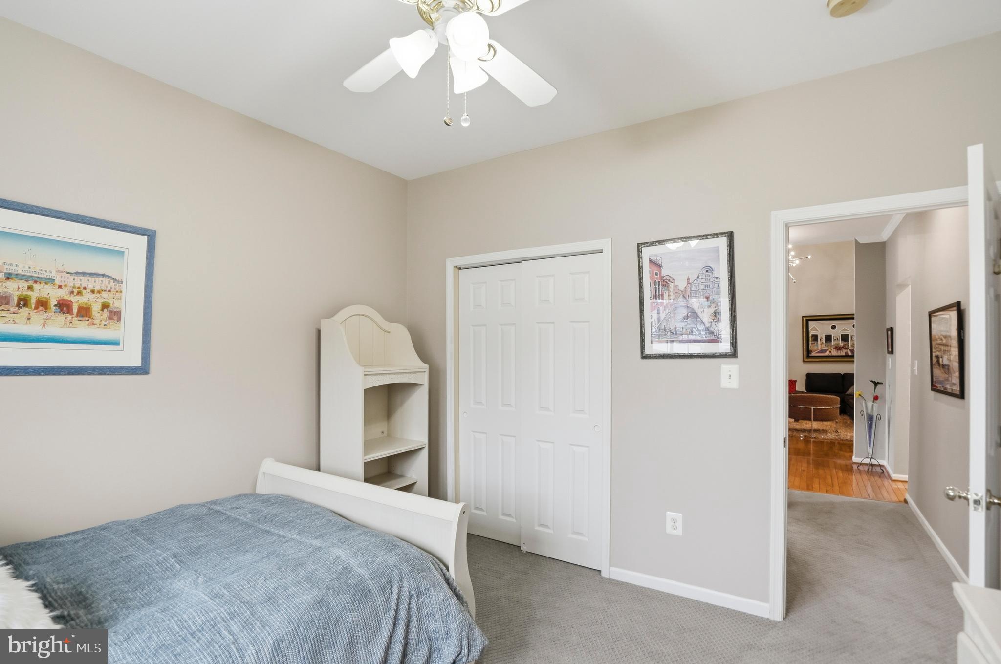 8941 Griffin Way, Unit 8941 Baltimore, MD 21208 - Photo 25 of 49 a bedroom with a bed and a chandelier