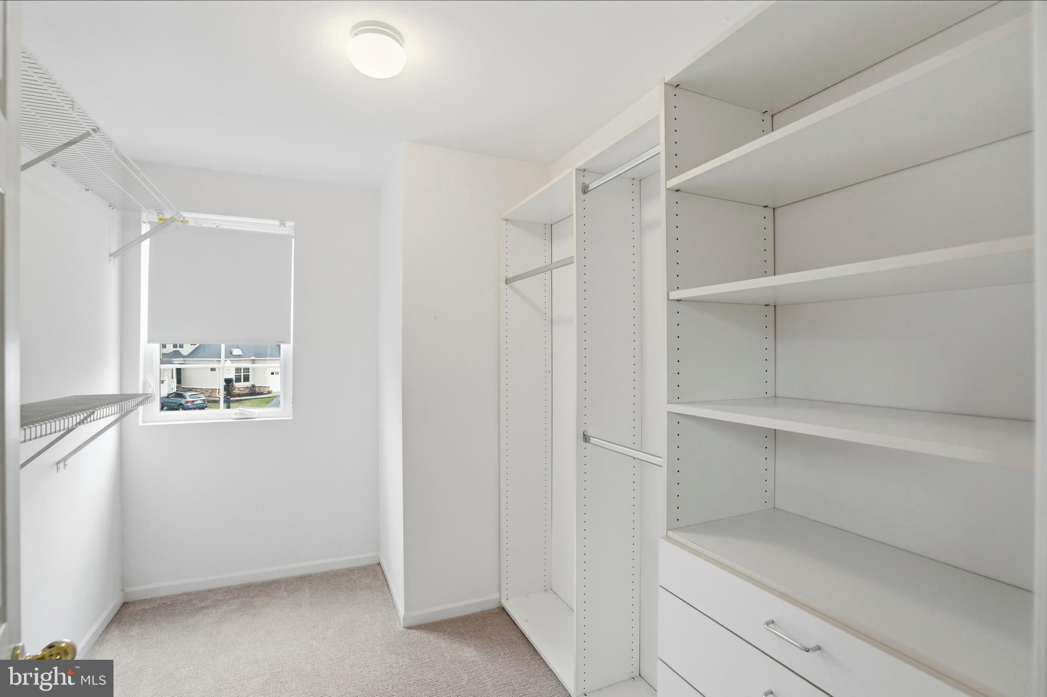 8941 Griffin Way, Unit 8941 Baltimore, MD 21208 - Photo 29 of 49 a view of walk in closet with empty racks