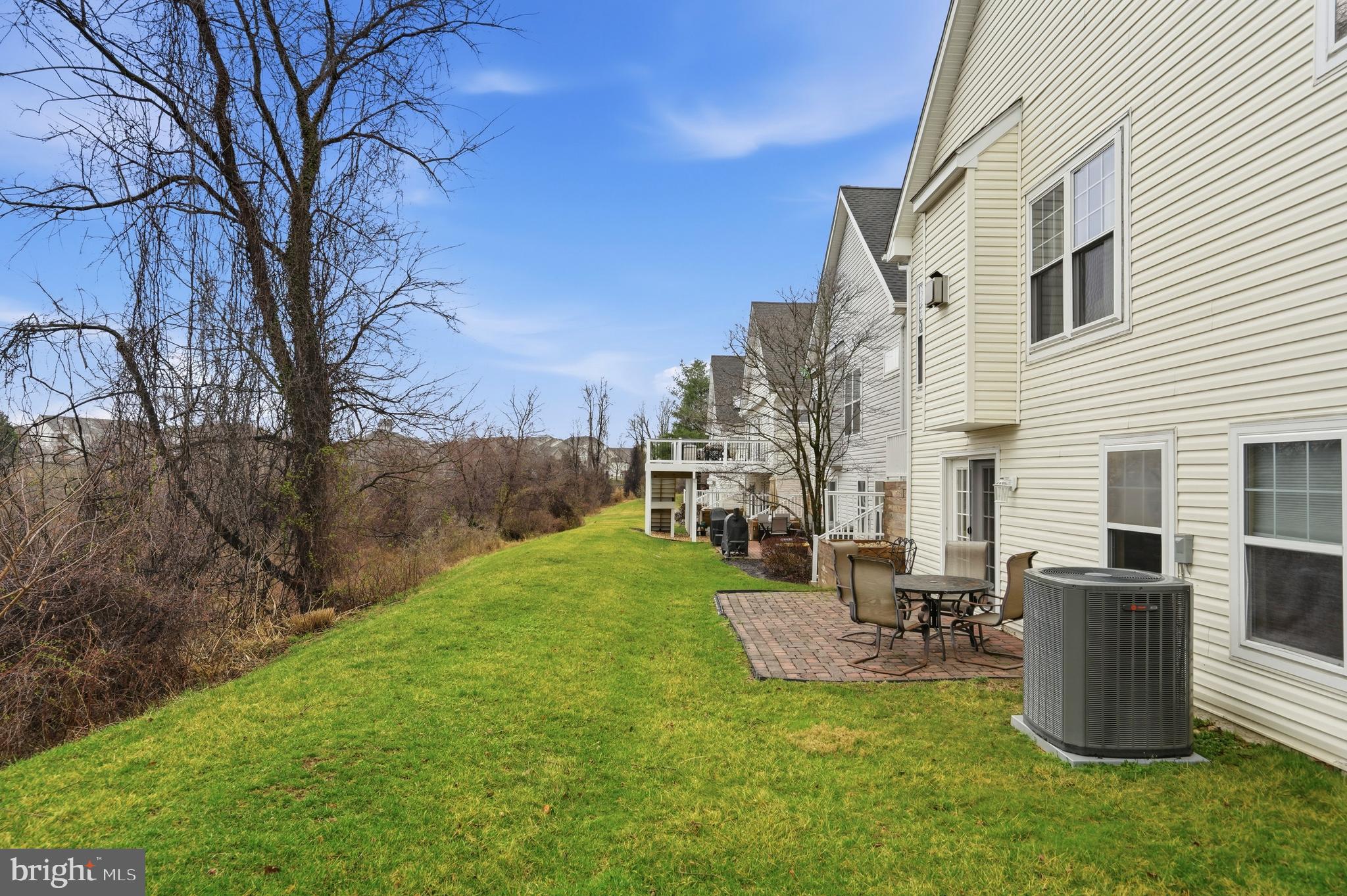 8941 Griffin Way, Unit 8941 Baltimore, MD 21208 - Photo 43 of 49 a view of a patio with couches chairs potted plants and a big yard