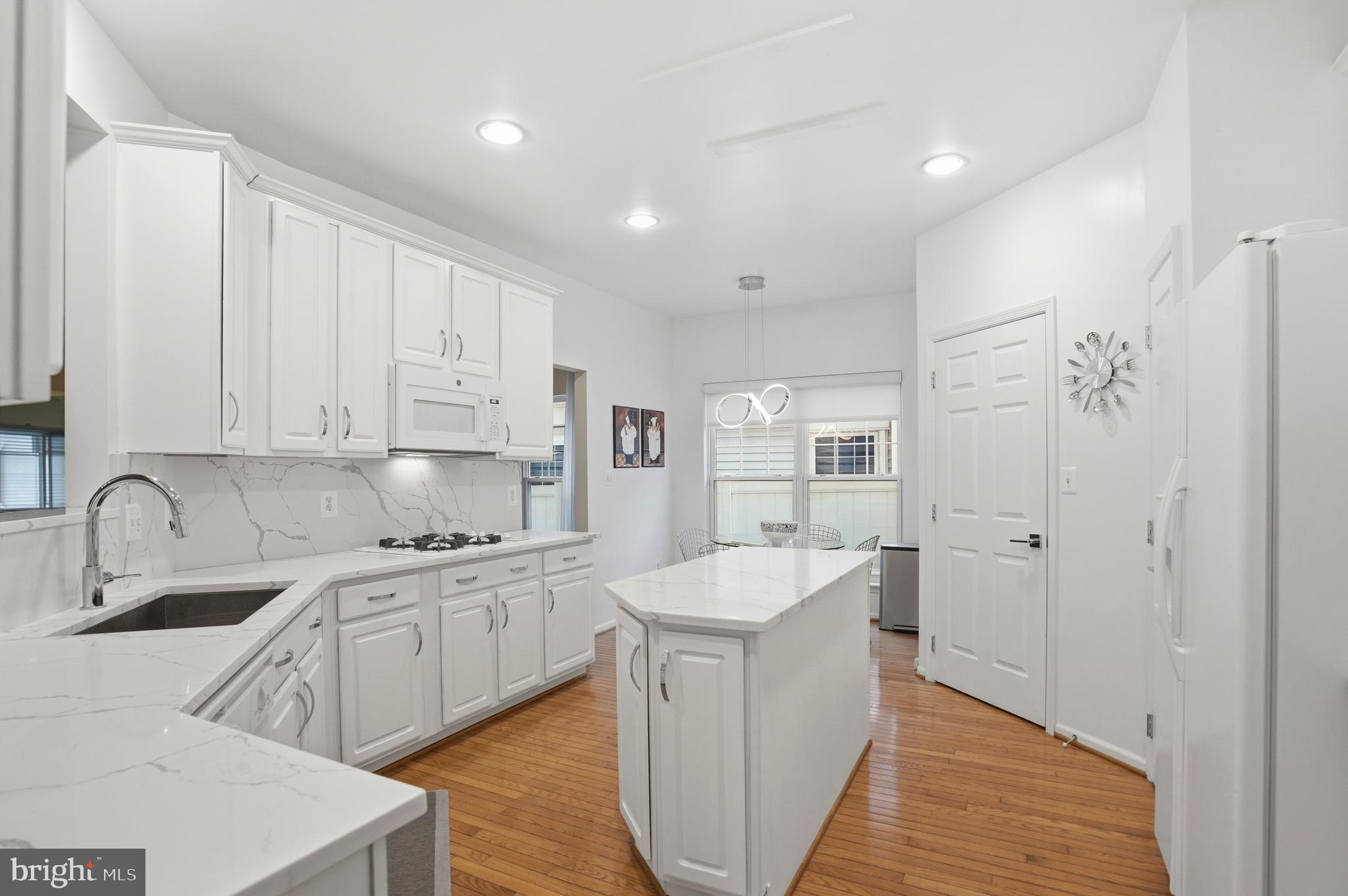 8941 Griffin Way, Unit 8941 Baltimore, MD 21208 - Photo 10 of 49 a kitchen with sink a refrigerator and cabinets
