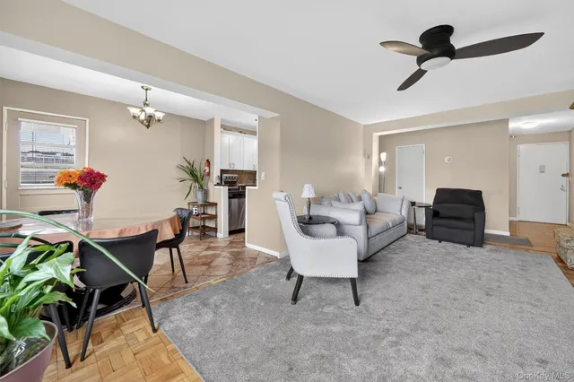 a view of a dining room with furniture and chandelier