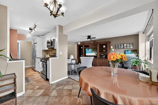 a kitchen with stainless steel appliances granite countertop a stove refrigerator and microwave