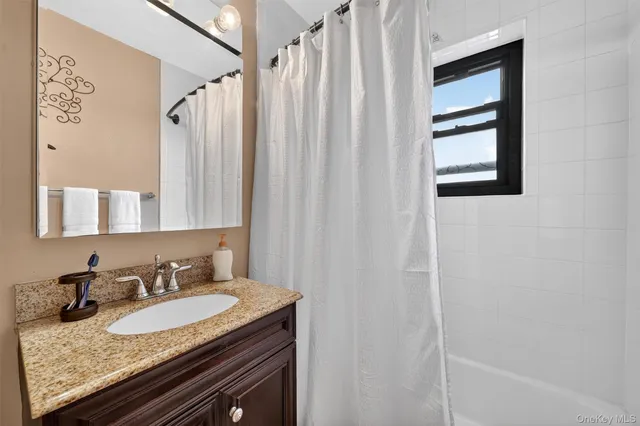 a living room with furniture large window and a flat screen tv