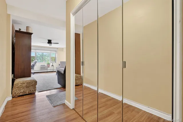 a view of a hallway with wooden floor