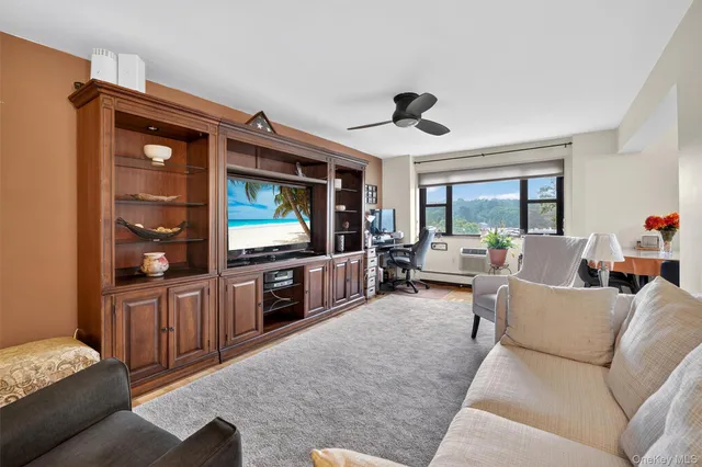 a living room with furniture a mirror and a lamp