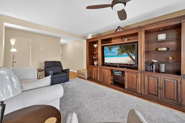 a view of a workspace with furniture and a window