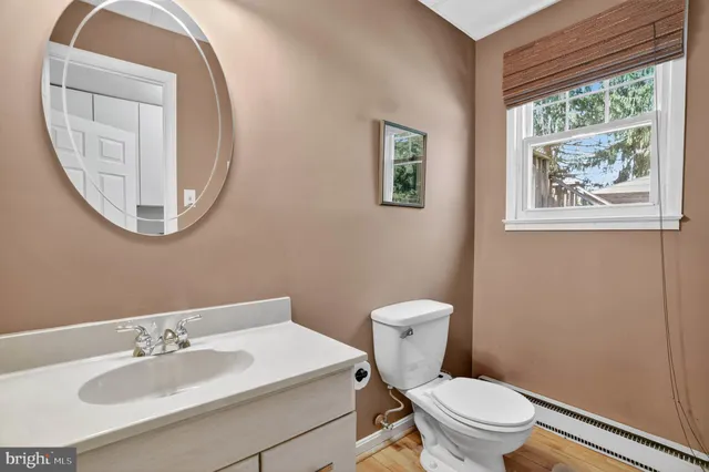 a bathroom with a toilet a sink and a mirror