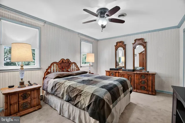 a bedroom with a large bed and a chandelier