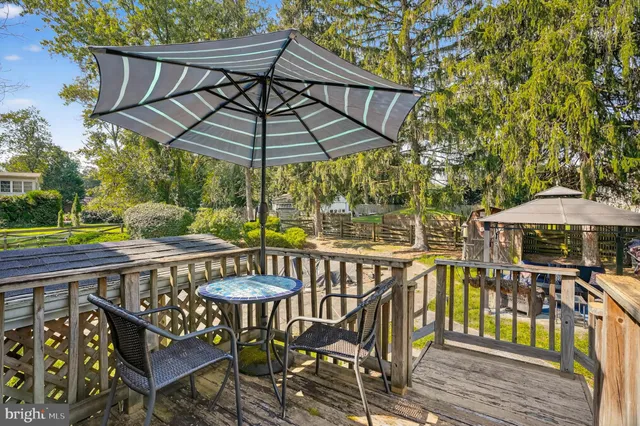 a view of a patio with furniture and table under an umbrella