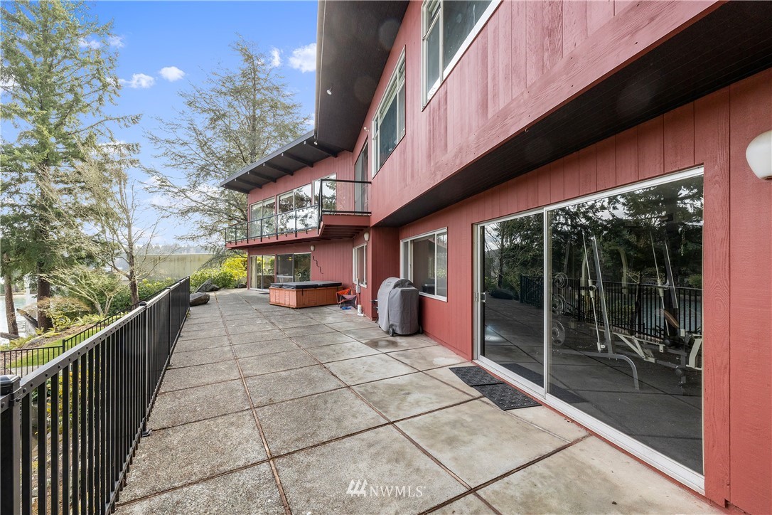 1600 Madrona Point Bremerton, WA 98312 - Photo 35 of 40 a view of a patio with table and chairs and floor to ceiling window and tree