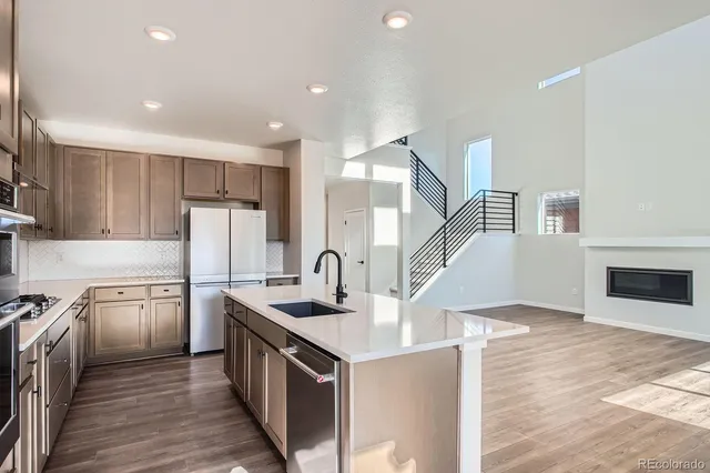 a kitchen with kitchen island a sink appliances and cabinets