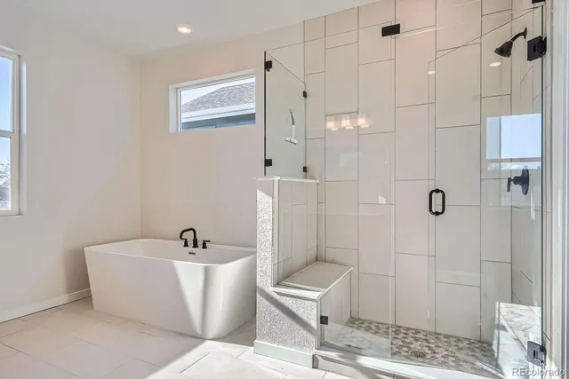 a bathroom with a bathtub and shower