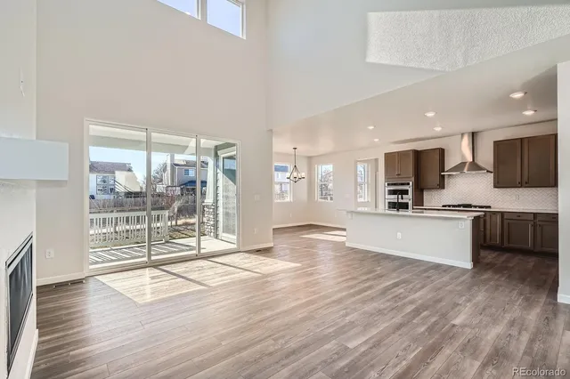 a large kitchen with kitchen island a large counter space a sink appliances and cabinets